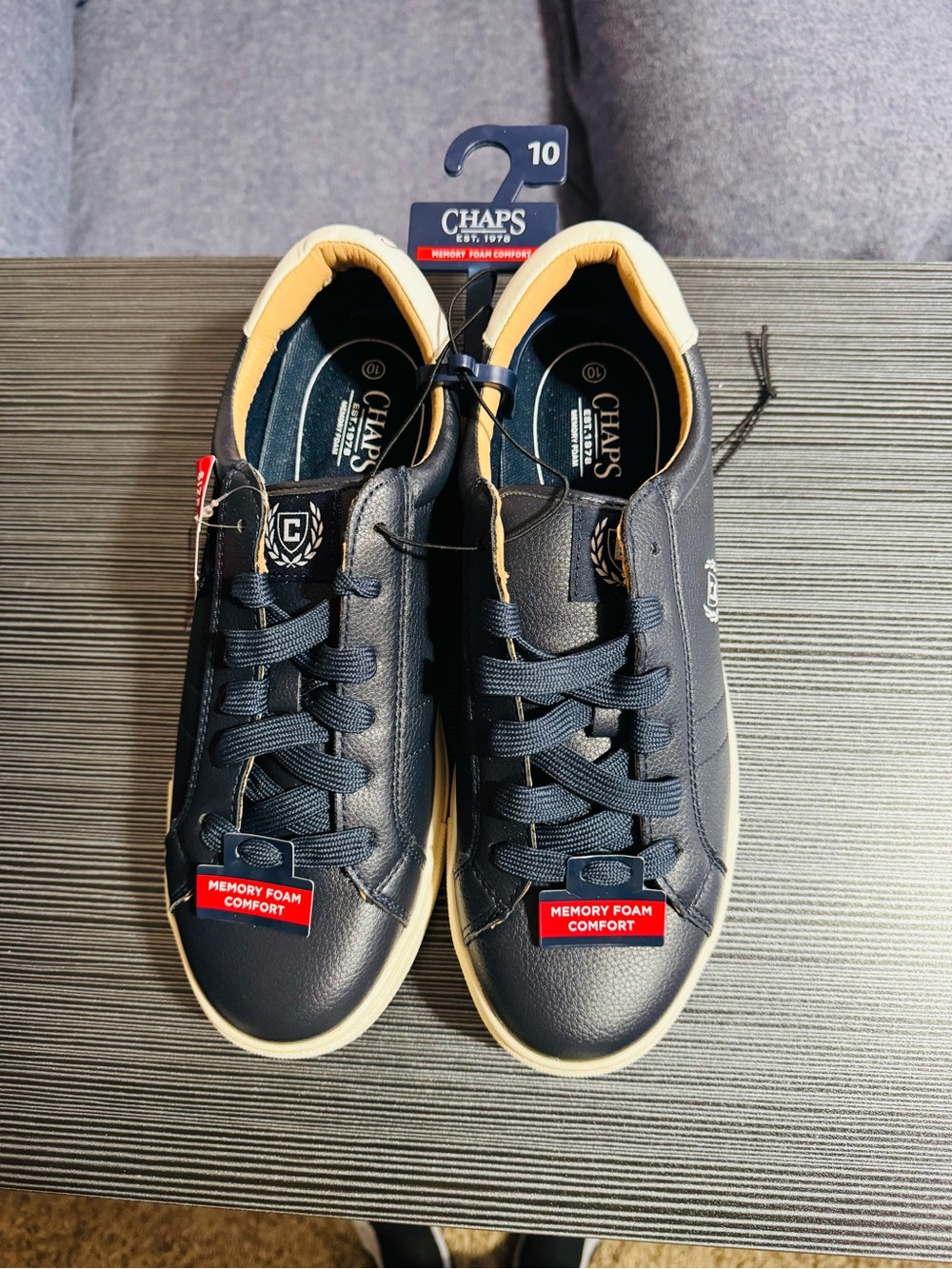 These are new navy blue Chaps branded sneakers with a memory foam insole.